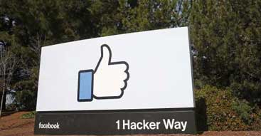 Facebook company entrance sign showing thumbs up logo